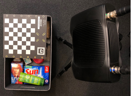 Camera facing a box with objects and a calibration board